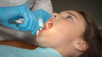 How Old Are Most People Who Choose Full-Mouth Dental Implants? (What the Research Really Shows) 5 Young adult consulting dentist about full-mouth dental implants treatment options