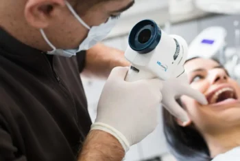 The Rise of Oral Nicotine Use and How it Might Affect Your Oral Health 3 Dentist examining patient for precancerous oral lesions caused by oral nicotine products