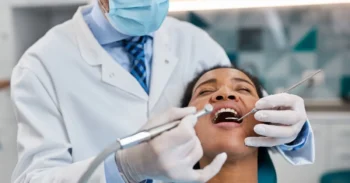 Patient receiving preventive dental care during cold weather winter checkup visit