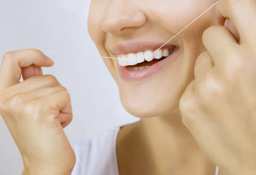 Can Flossing Stabilize Your Blood Sugar? 9 Dentist demonstrating proper flossing technique for improved oral hygiene